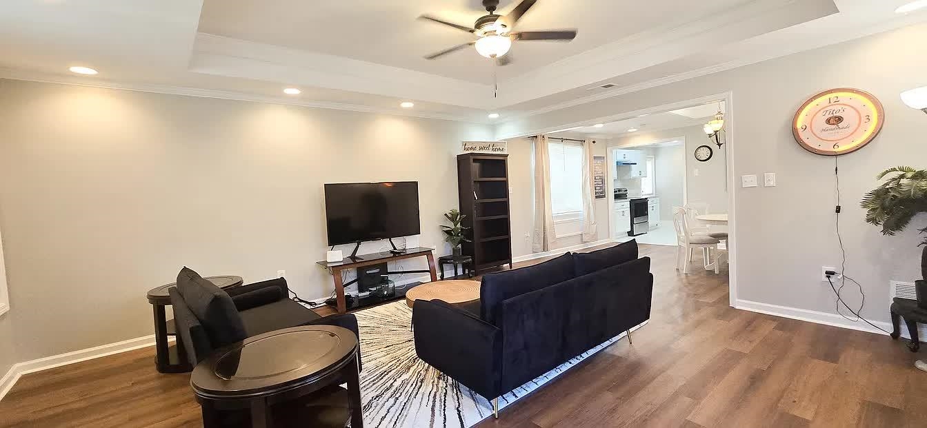 15 South Cox Street Memphis, TN 38104 - Photo 17 of 20 a living room with furniture a large window and a flat screen tv