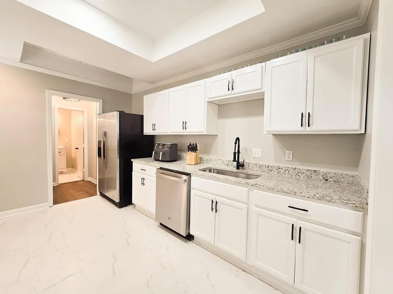15 South Cox Street Memphis, TN 38104 - Photo 7 of 20 a kitchen with a sink a refrigerator and cabinets