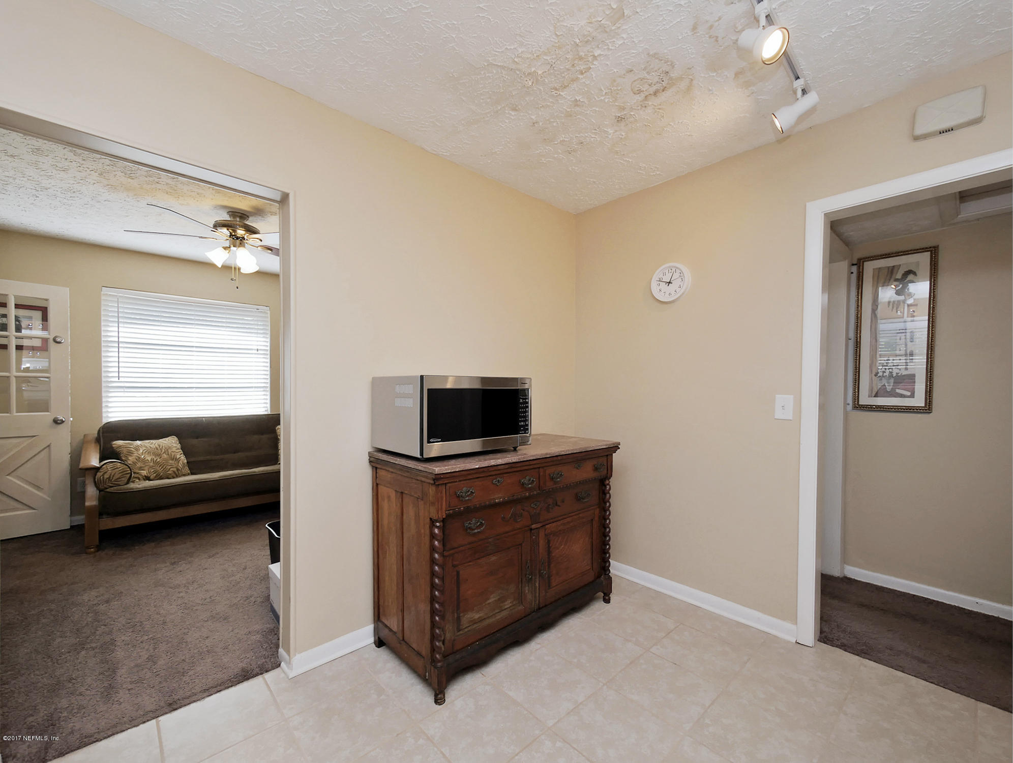 6837 Merrill Road Jacksonville, FL 32277 - Photo 13 of 13 a living room with furniture and a flat screen tv