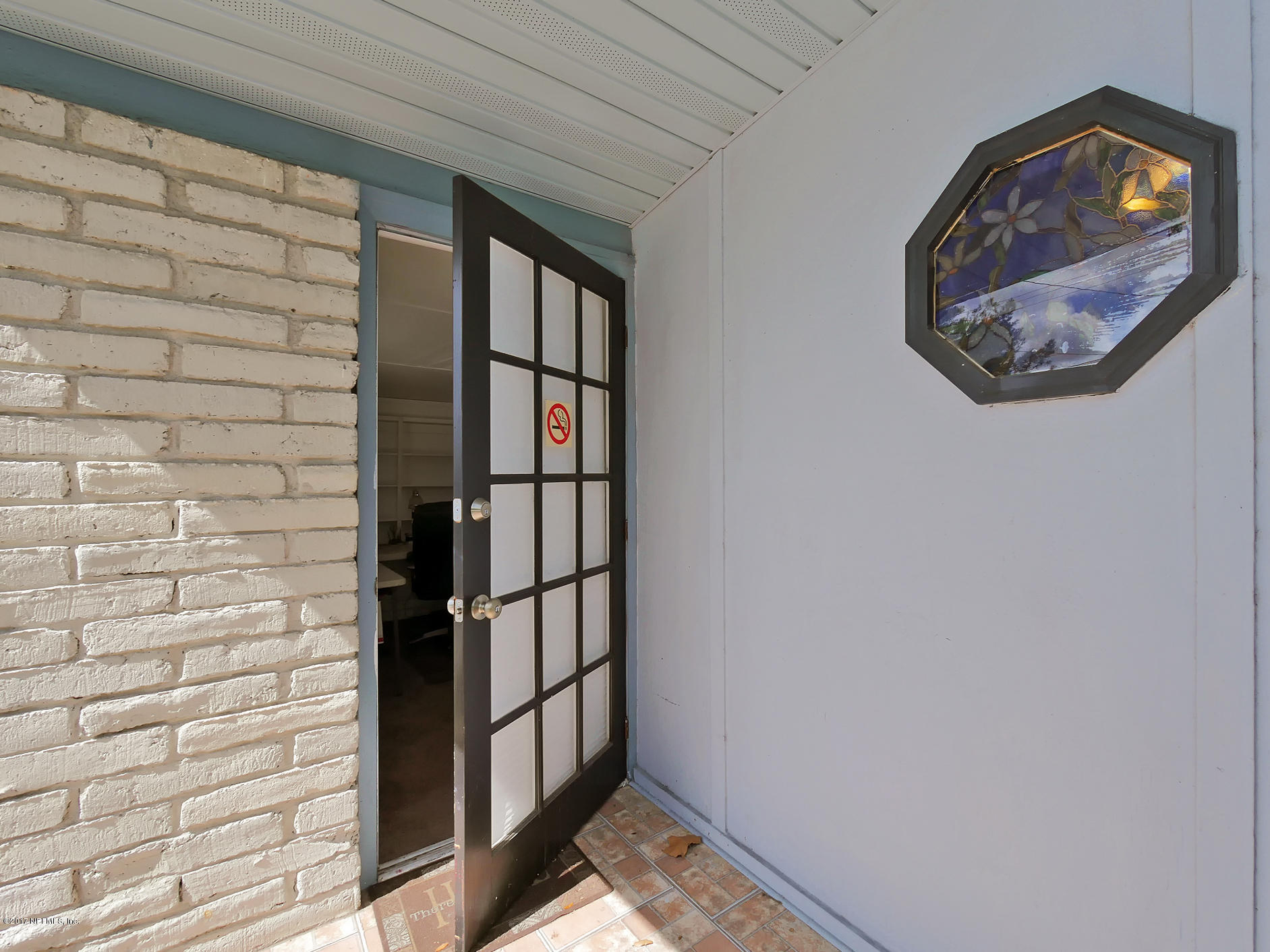 6837 Merrill Road Jacksonville, FL 32277 - Photo 4 of 13 a view of a hallway with wooden walls