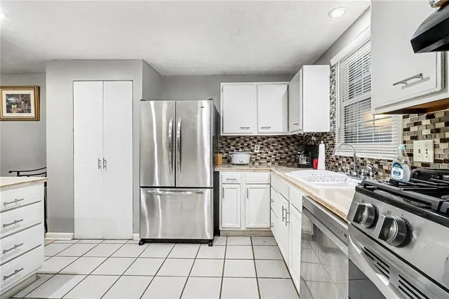 a kitchen with a stove top oven and cabinets