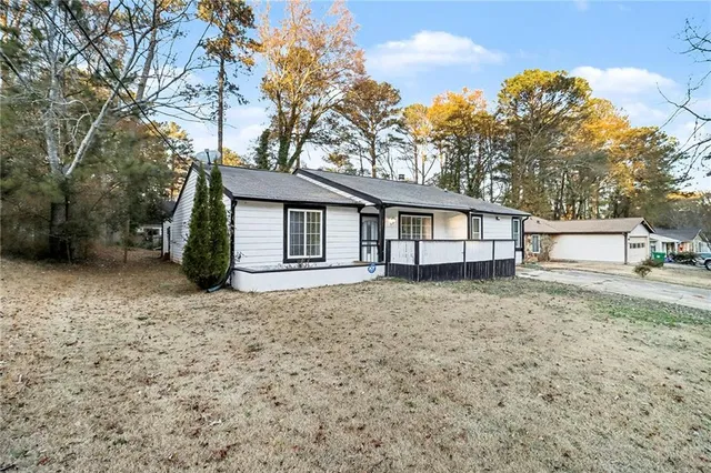 a view of a house with a backyard