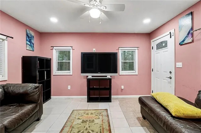 a living room with furniture and a flat screen tv