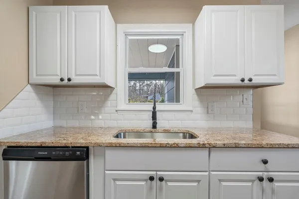 a kitchen with a sink and a window