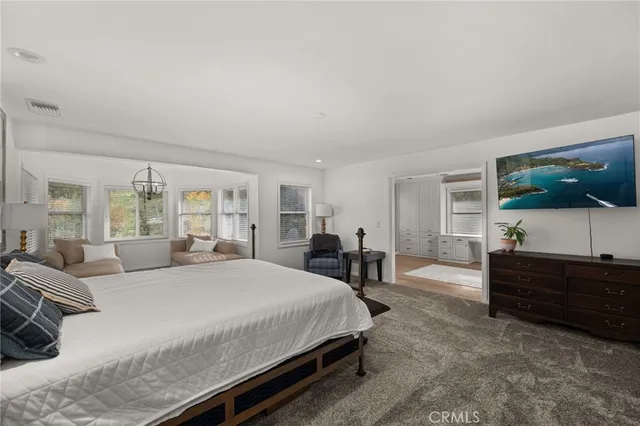 a bathroom with a granite countertop double vanity sink and mirror