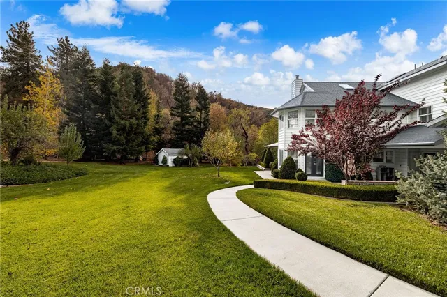 an aerial view of a house with yard swimming pool and outdoor seating