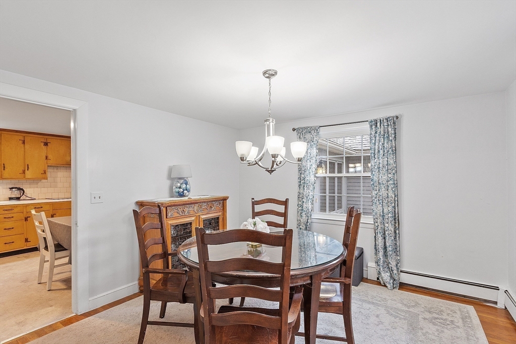 3 Thoreau Road Acton, MA 01720 - Photo 11 of 42 a view of a dining room with furniture and chandelier