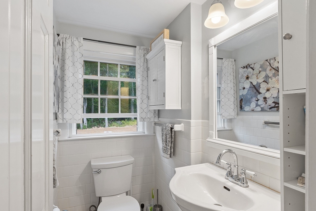 3 Thoreau Road Acton, MA 01720 - Photo 18 of 42 a bathroom with a toilet sink and mirror