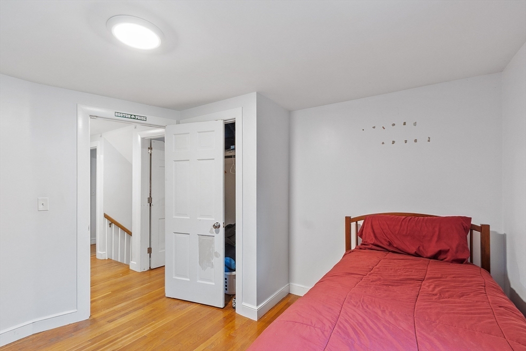 3 Thoreau Road Acton, MA 01720 - Photo 30 of 42 a bedroom with a bed and wooden floor