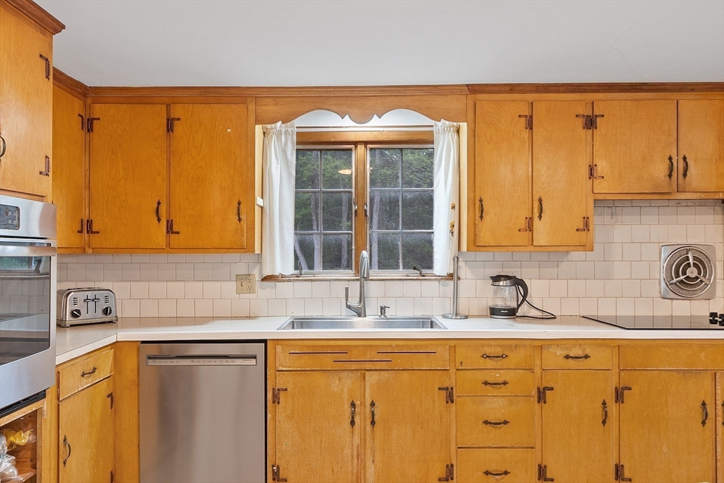 3 Thoreau Road Acton, MA 01720 - Photo 5 of 42 a kitchen with stainless steel appliances a sink a stove and a refrigerator