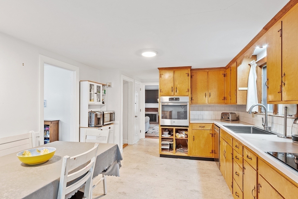 3 Thoreau Road Acton, MA 01720 - Photo 6 of 42 a kitchen with stainless steel appliances granite countertop a sink a stove and a refrigerator