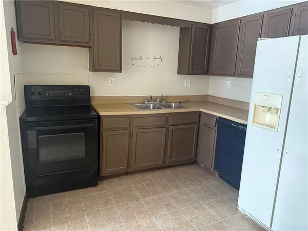 a kitchen with a cabinets and white appliances