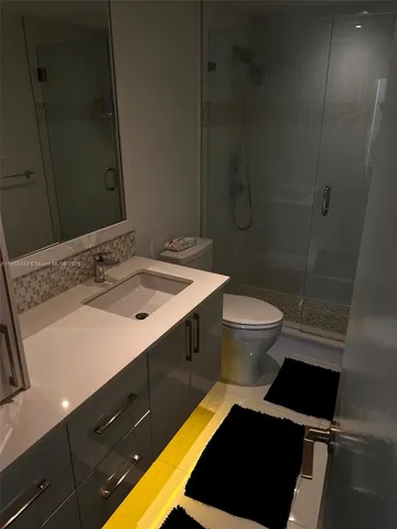 a view of a hallway with wooden floor and a living room