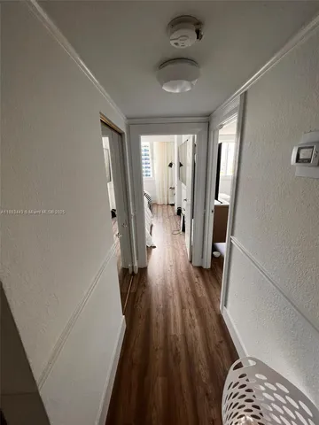 a view of bedroom and bedroom with wooden floor