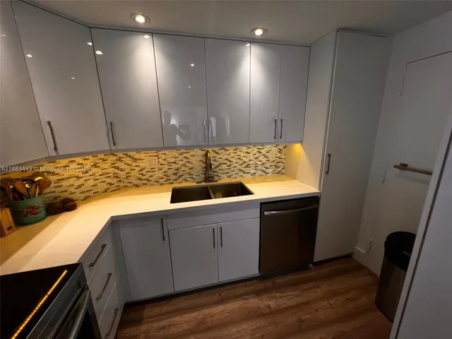 a kitchen with a sink and cabinets