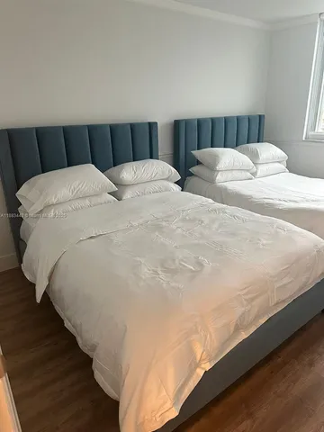 a view of a balcony with wooden floor