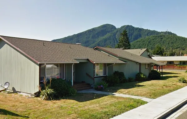 a view of house with yard