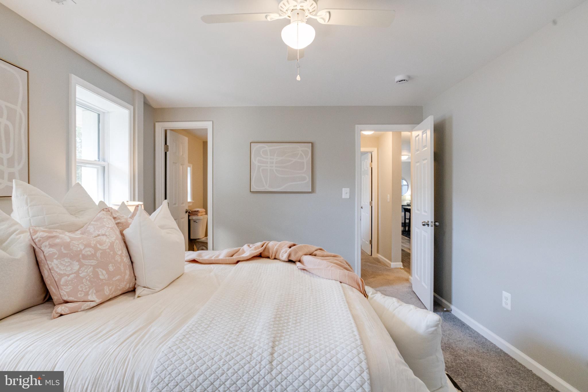 7540 Bay Front Road Sparrows Point, MD 21219 - Photo 45 of 63 a bedroom with a bed and a chandelier