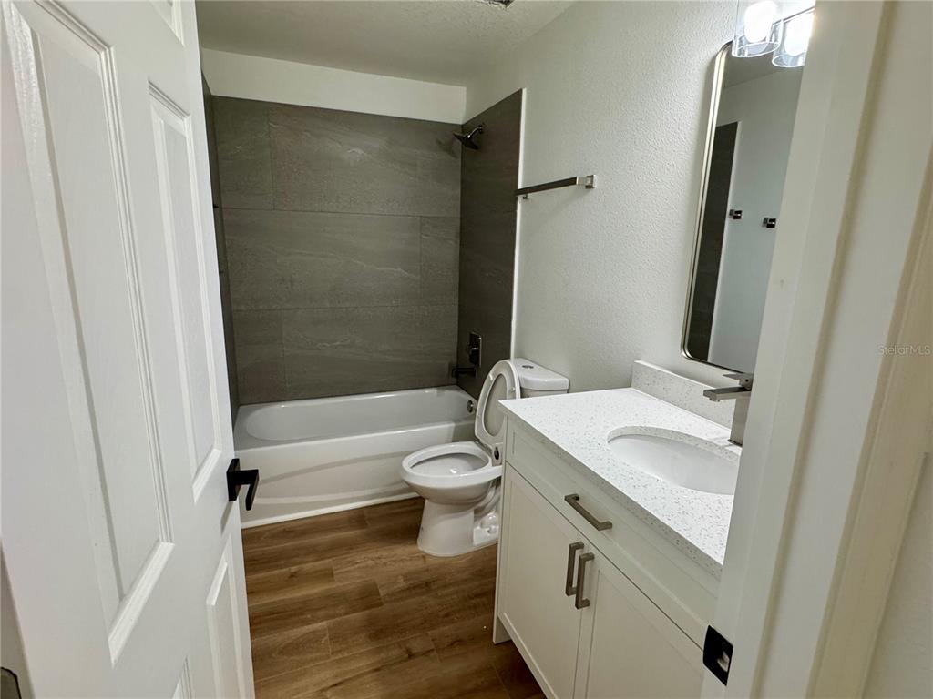 3401 South Highlands Avenue Inverness, FL 34452 - Photo 11 of 16 a bathroom with a granite countertop sink toilet a mirror and shower