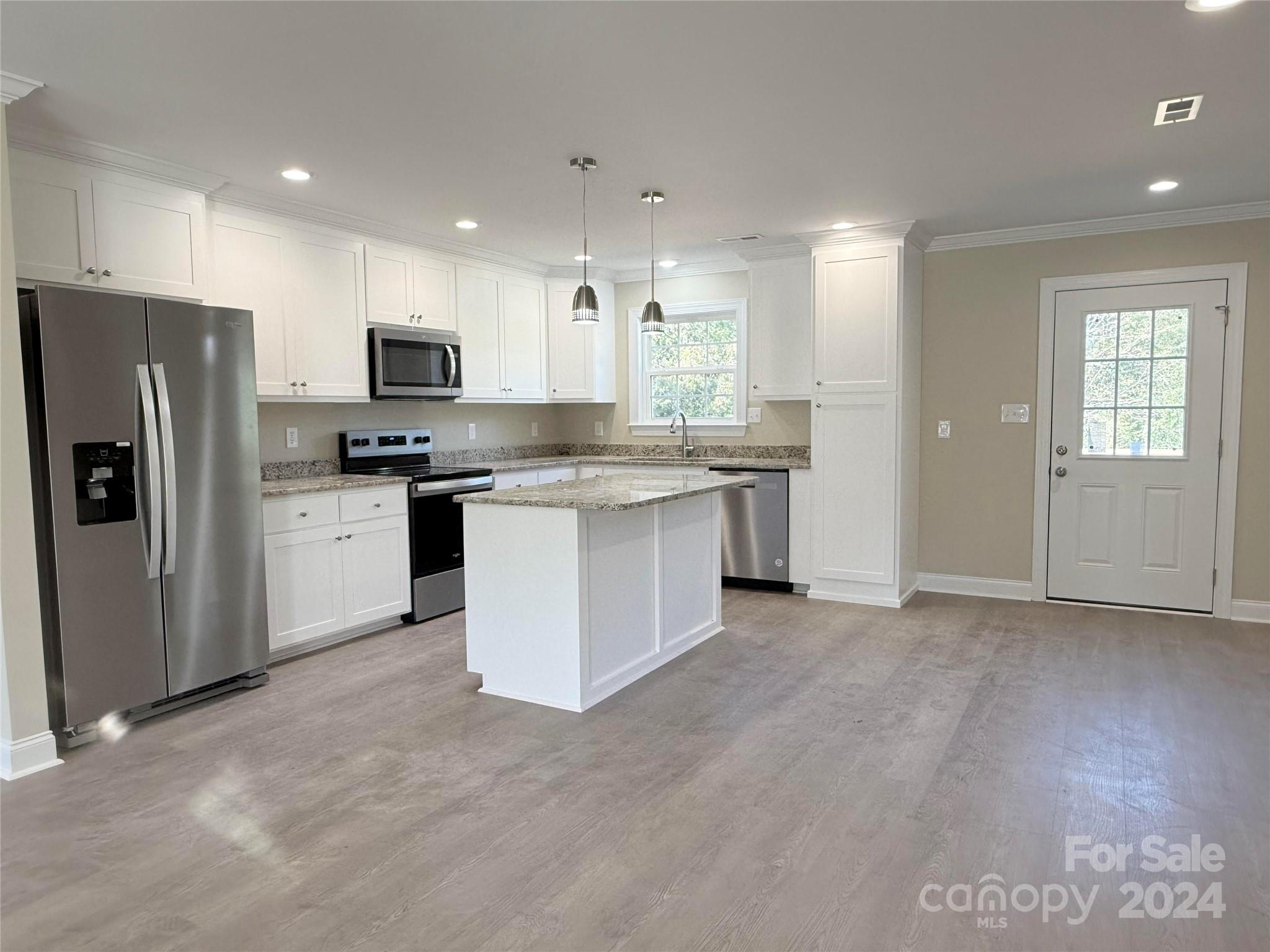2438-j B J B Denton Road Lancaster, SC 29720 - Photo 11 of 23 a kitchen with stainless steel appliances granite countertop a stove top oven a refrigerator a sink and a refrigerator