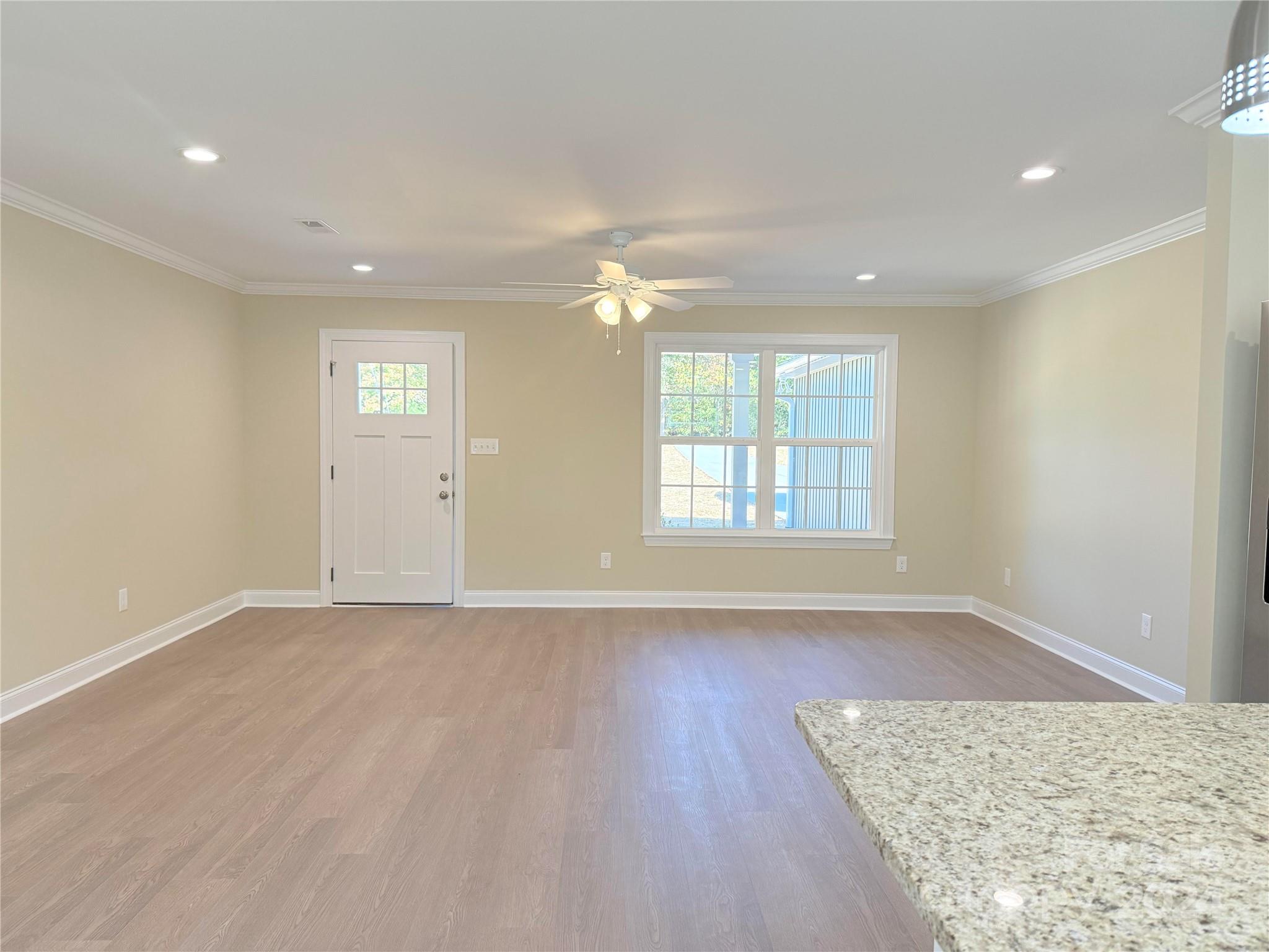 2438-j B J B Denton Road Lancaster, SC 29720 - Photo 16 of 23 wooden floor in an empty room with a window