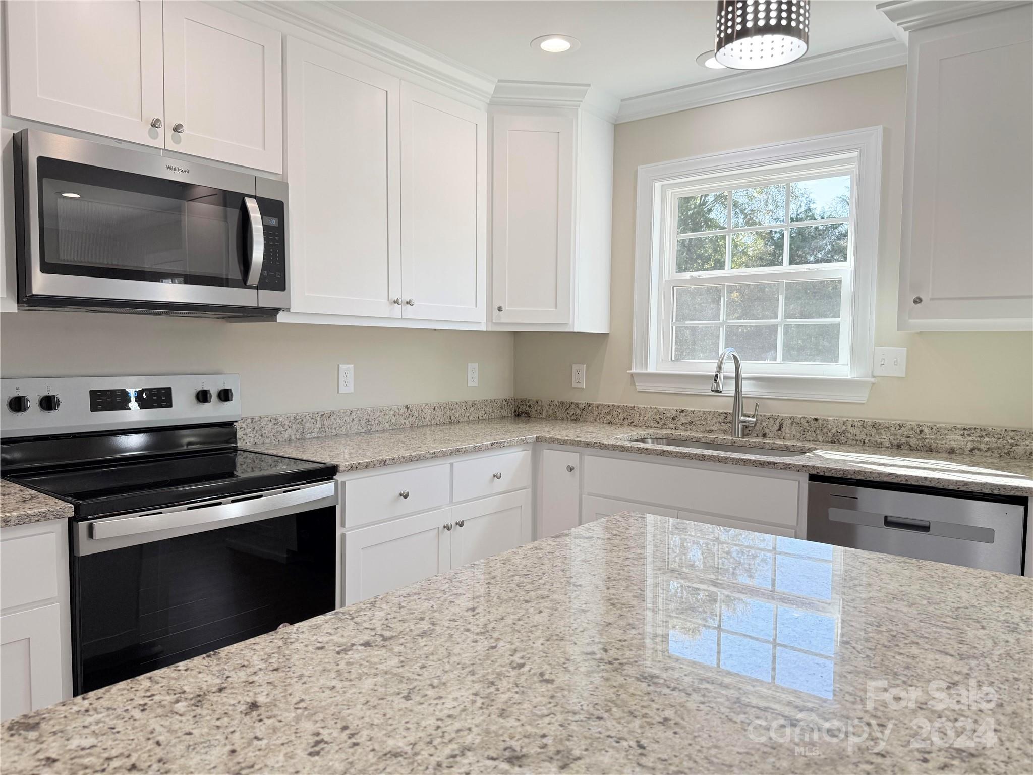 2438-j B J B Denton Road Lancaster, SC 29720 - Photo 17 of 23 a kitchen with granite countertop a stove a sink and a microwave