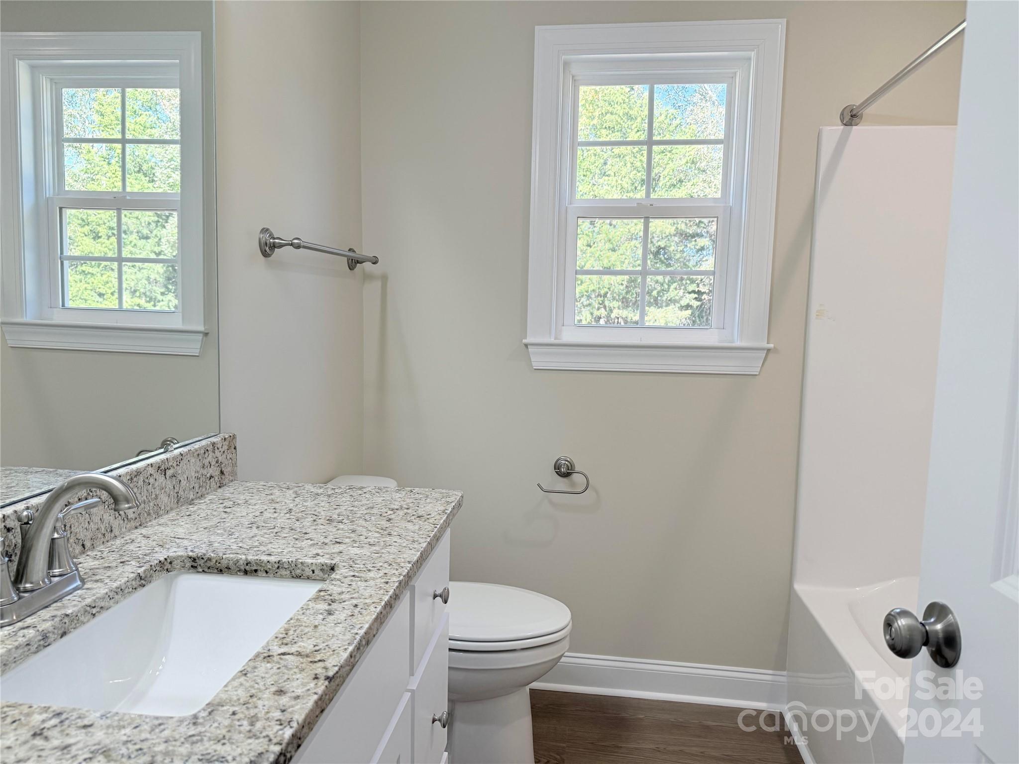 2438-j B J B Denton Road Lancaster, SC 29720 - Photo 18 of 23 a bathroom with a granite countertop sink toilet and mirror