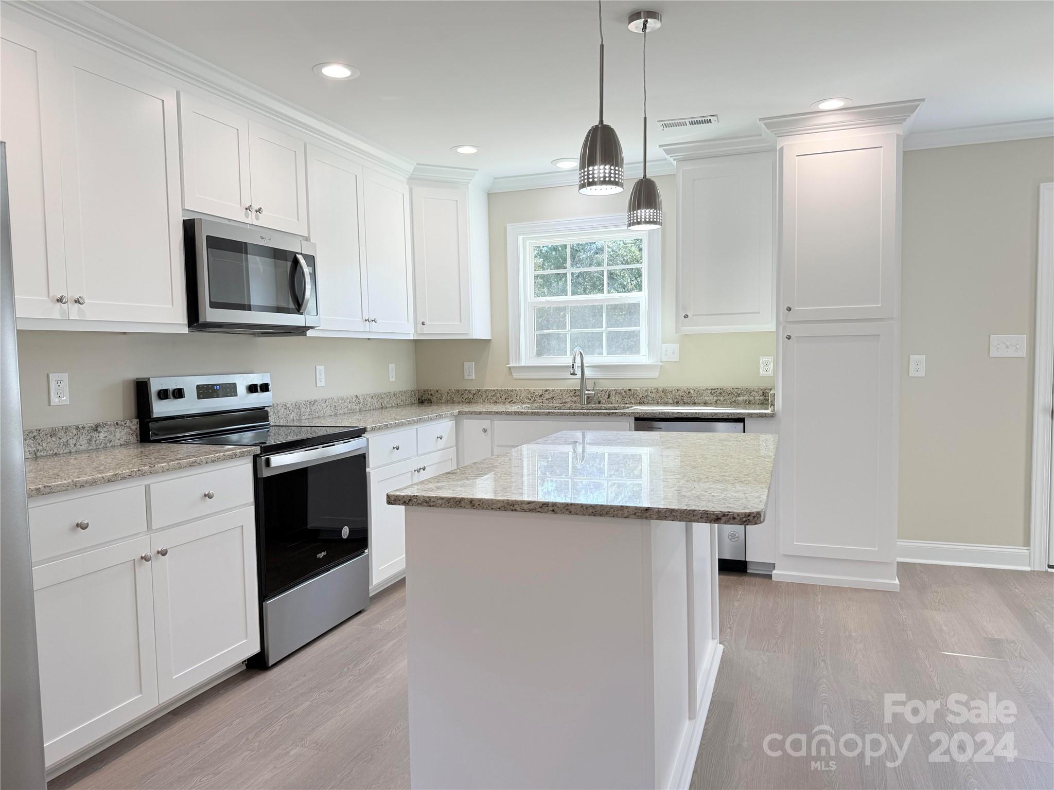 2438-j B J B Denton Road Lancaster, SC 29720 - Photo 20 of 23 a kitchen with granite countertop a sink stainless steel appliances and white cabinets