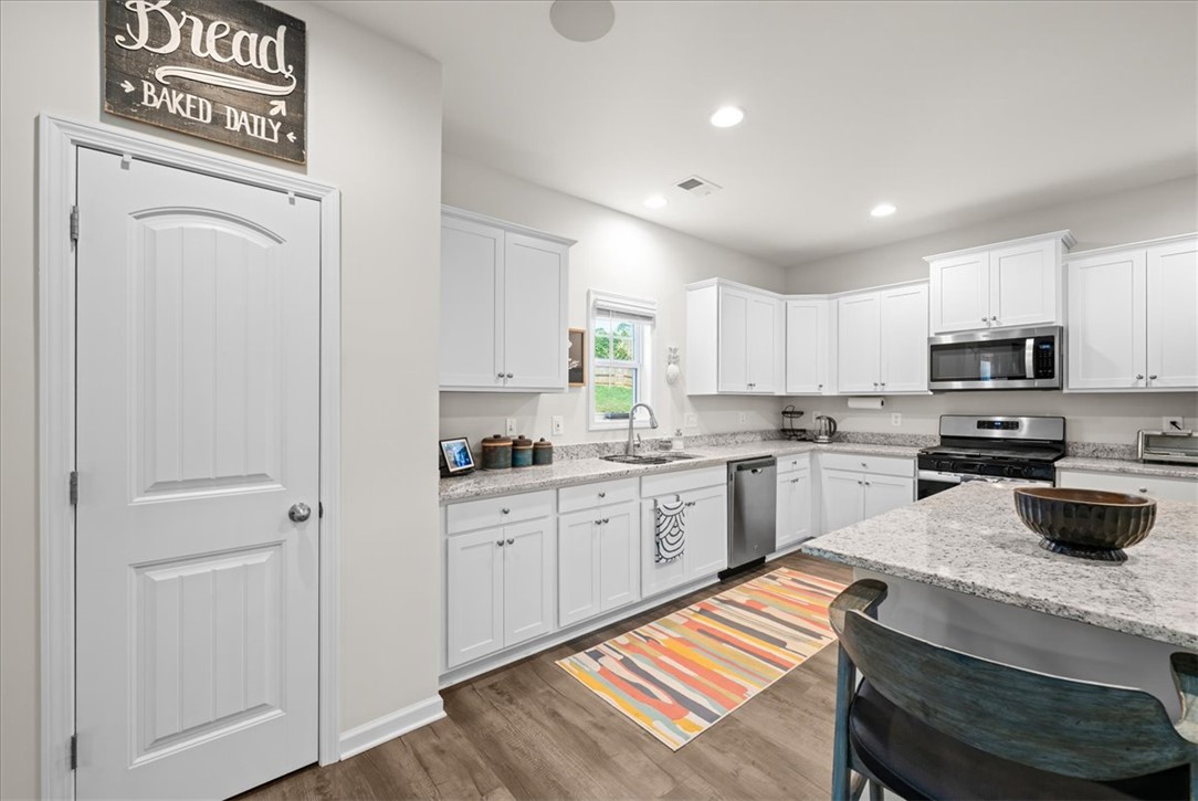 216 Carvel Trail Seneca, SC 29678 - Photo 16 of 46 This bright kitchen features ample cabinetry, a dedicated pantry, and an inviting island for casual dining.