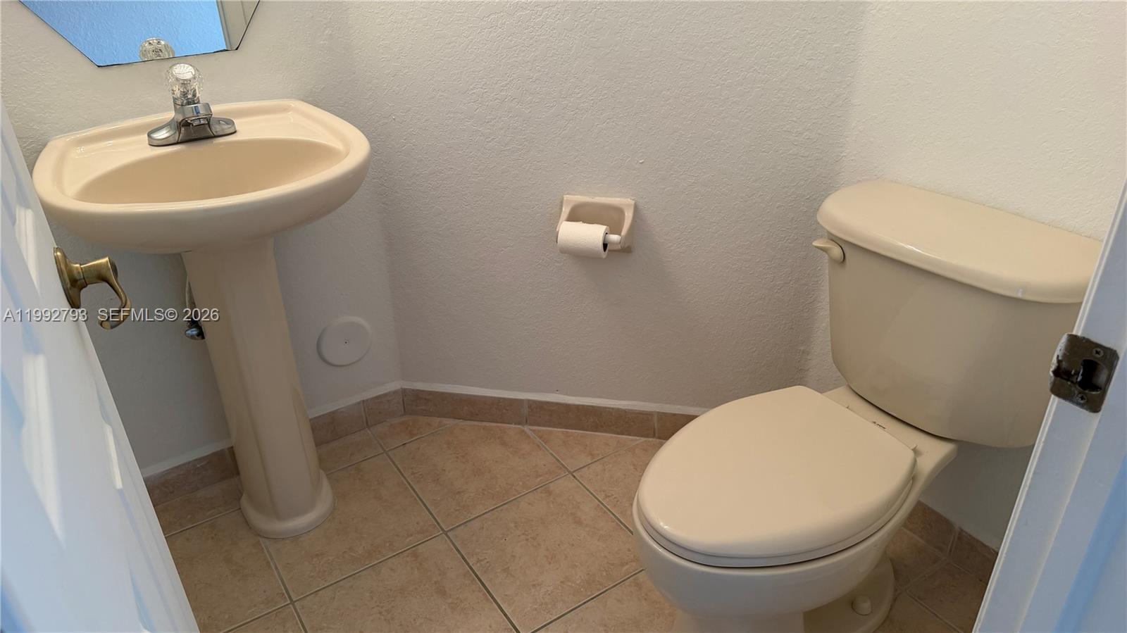 12260 Southwest 123rd Pass Miami, FL 33186 - Photo 5 of 14 a bathroom with a sink a toilet and a mirror