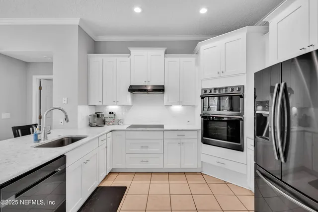 a living room with furniture a rug and a flat screen tv