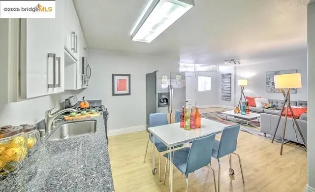 a kitchen with stainless steel appliances a stove top oven a sink and a refrigerator