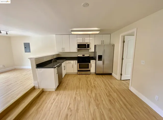a view of a room with wooden floor and window