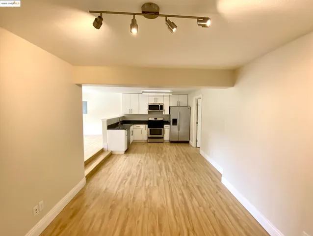 a view of a room with wooden floor and staircase
