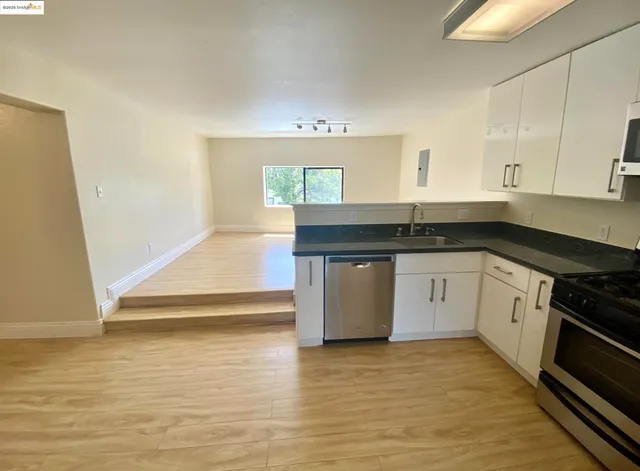 a kitchen with stainless steel appliances a refrigerator and a stove