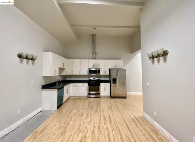 a kitchen with stainless steel appliances a refrigerator sink and microwave