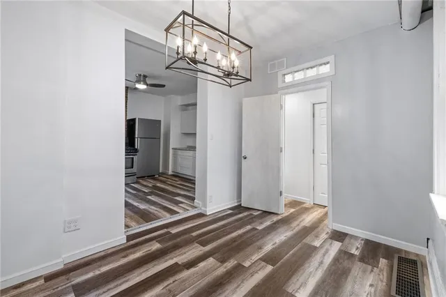 a view of a chandelier fan and wooden floor