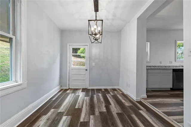 a view of a hallway view with wooden floor and staircase