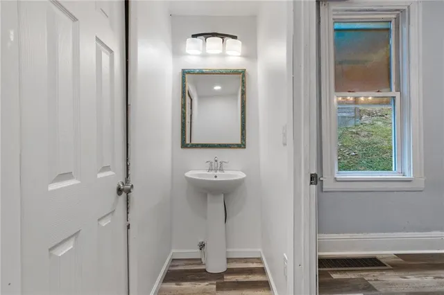 a bathroom with a sink a mirror and a shower