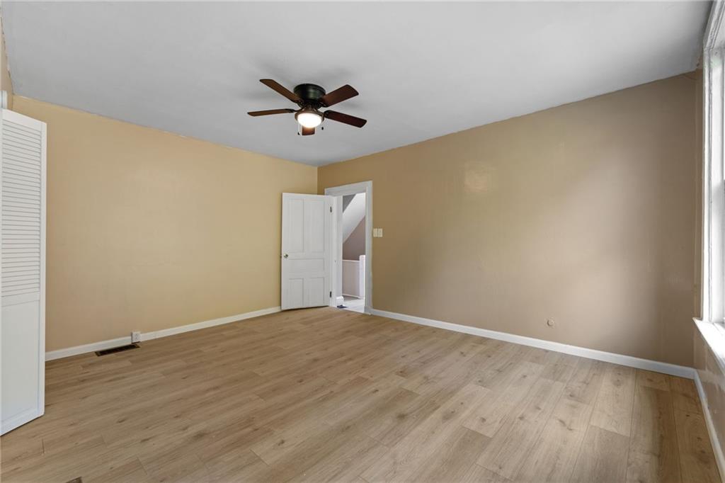 124 Silver Street Pittsburgh, PA 15209 - Photo 17 of 28 a view of room with wooden floor and ceiling fan