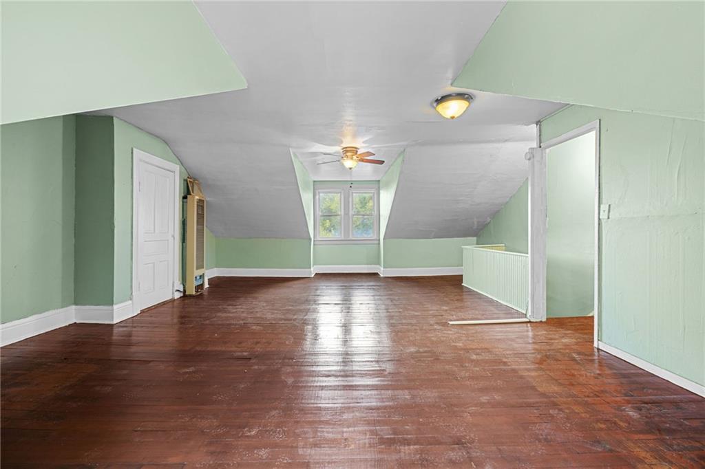 124 Silver Street Pittsburgh, PA 15209 - Photo 22 of 28 a view of an empty room with window and wooden floor