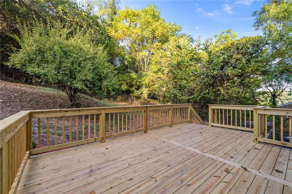124 Silver Street Pittsburgh, PA 15209 - Photo 24 of 28 a balcony with wooden floor and fence