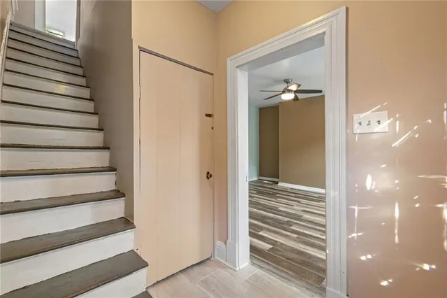 a view of a hallway with wooden floor and entryway