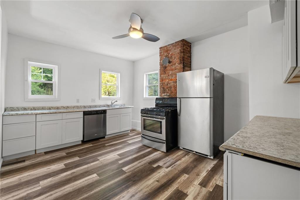 124 Silver Street Pittsburgh, PA 15209 - Photo 7 of 28 a kitchen with a refrigerator and a sink