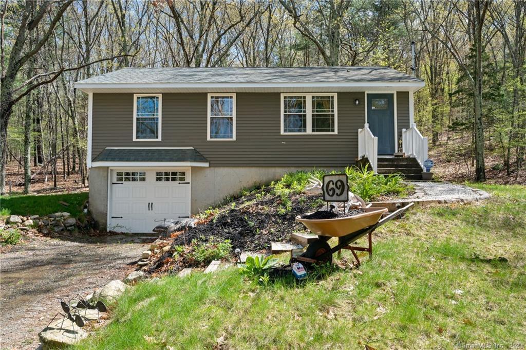 a view of a house with backyard sitting area and garden