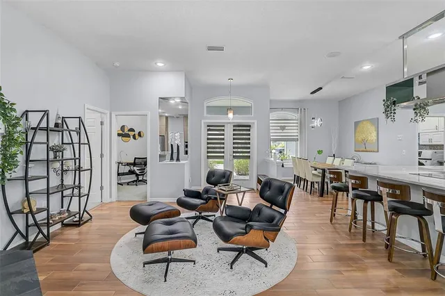 a living room with furniture wooden floor and a table