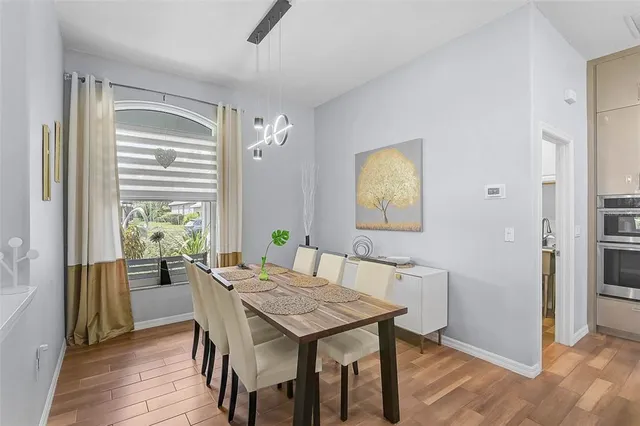 a view of a dining room with furniture window and wooden floor