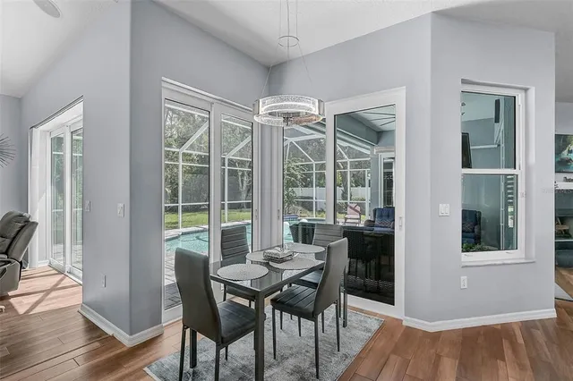 a view of a dining room with furniture window and wooden floor