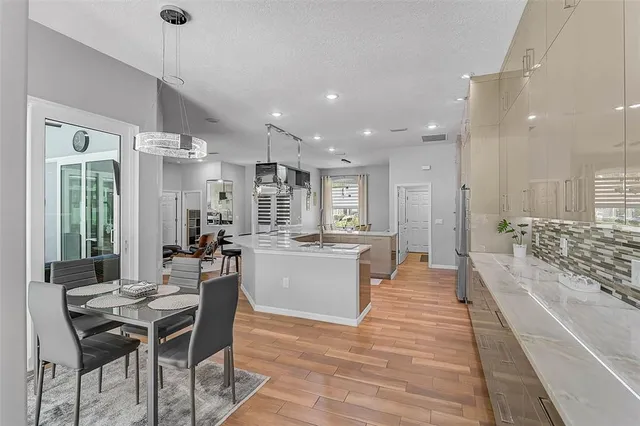 a large kitchen with a table and chairs in it