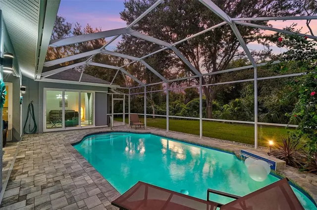 a view of a backyard with a swimming pool